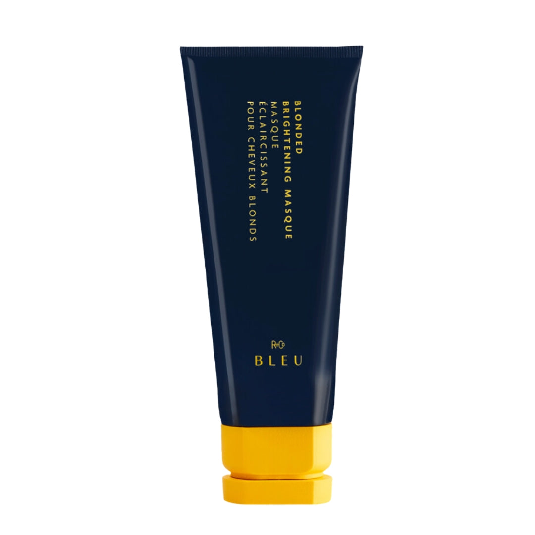 A tube of Blonded Brightening Masque with a navy body and yellow cap, labeled with the brand name 'R+Co BLEU'.