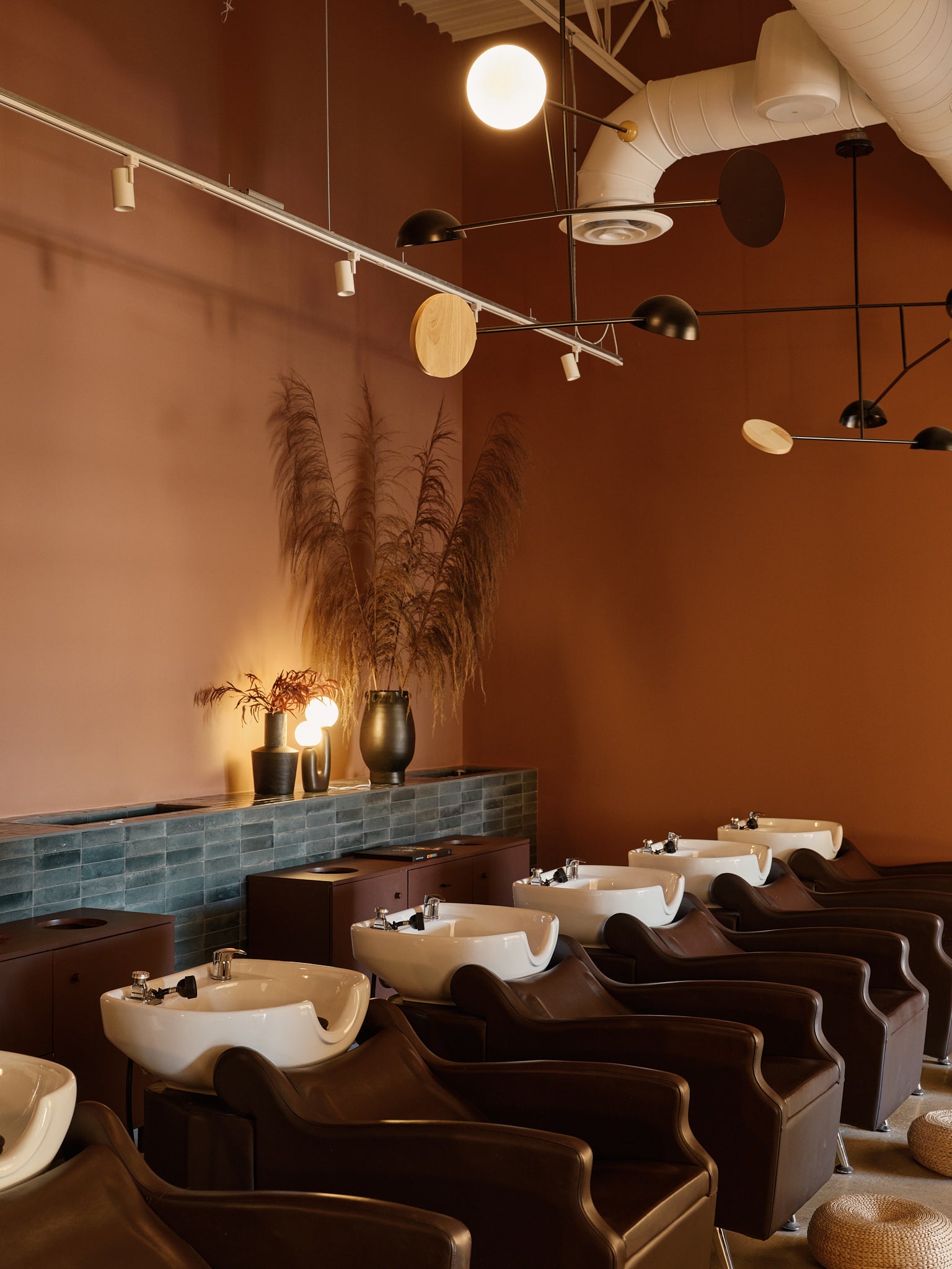 Inside Revel Workshop at the shampoo stations with sinks and comfortable chairs