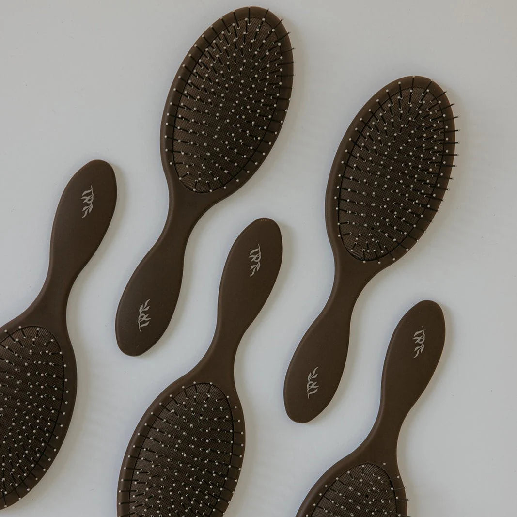 Set of six brown Willow detangling hairbrushes with visible brand logo on a white background