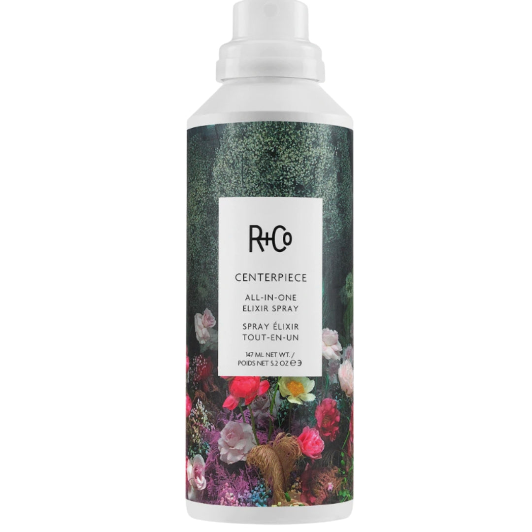 Bottle of R+Co Centerpiece All-in-One Elixir Spray with floral design