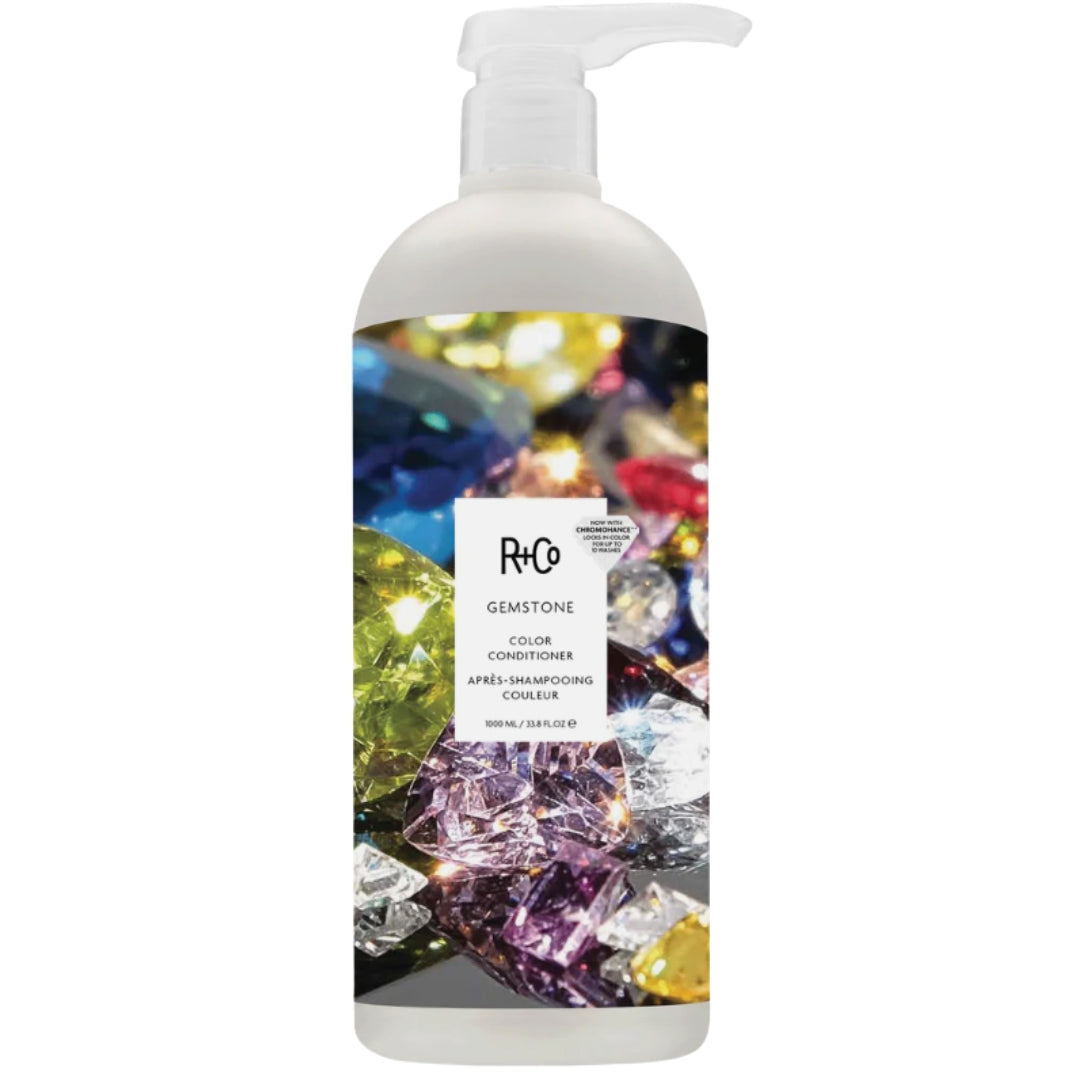 A bottle of R+Co Gemstone Color Conditioner with a colorful gemstone image on the label.