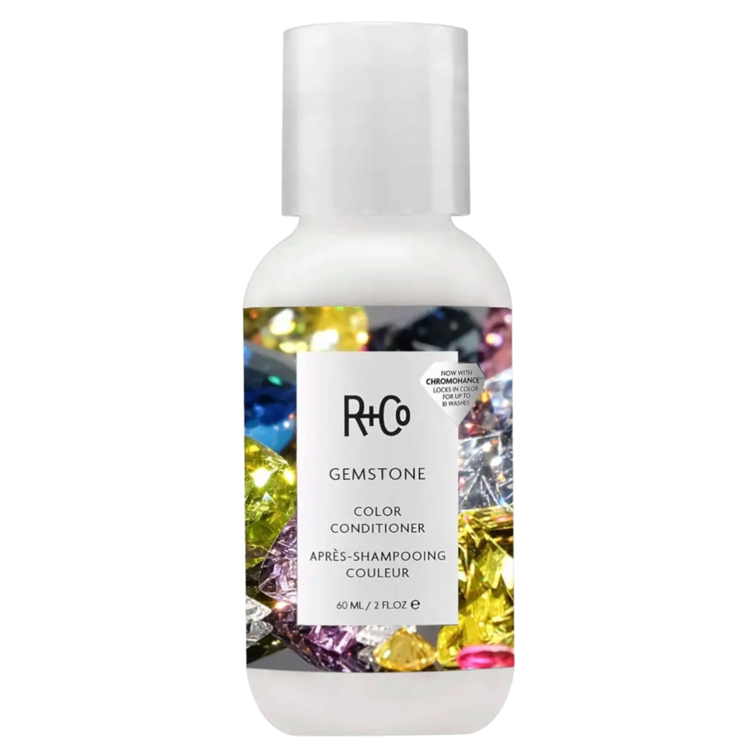 A travel size bottle of R+Co Gemstone Color Conditioner with a colorful gemstone image on the label.