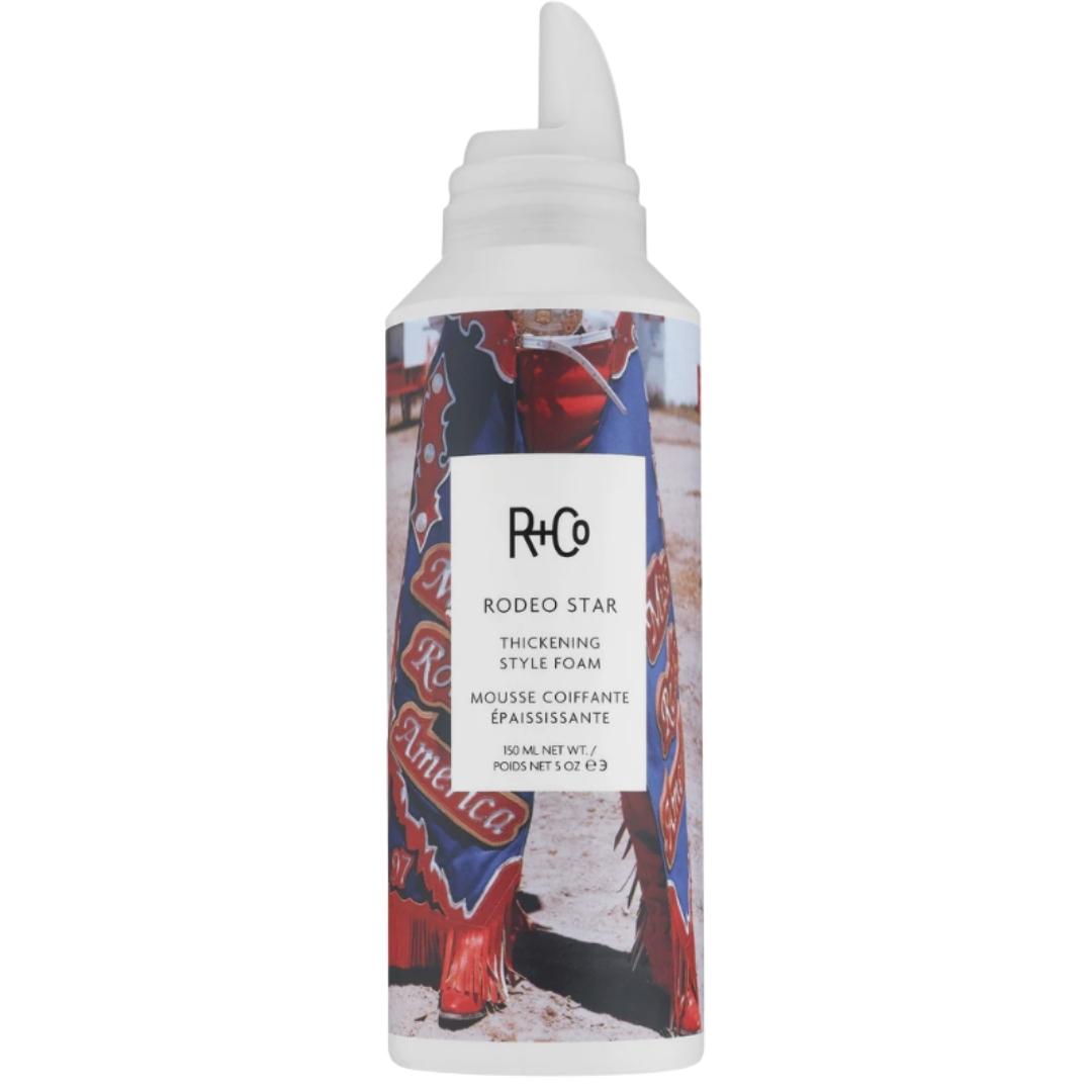 White container of RODEO STAR Thickening Styling Foam by R+Co with a colorful label featuring a person wearing a cowboy boots.