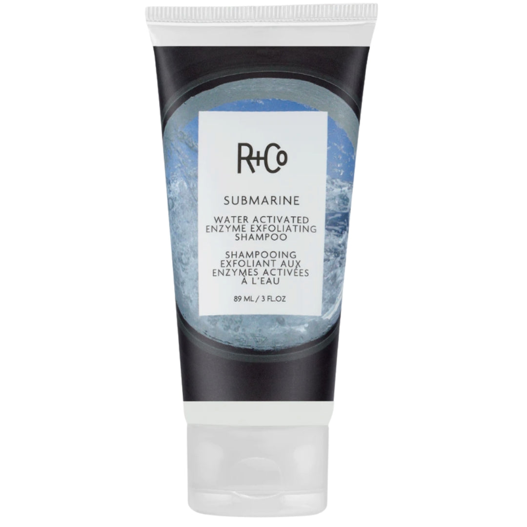 Black and white tube of R+Co Submarine Water Activated Enzyme Exfoliating Shampoo