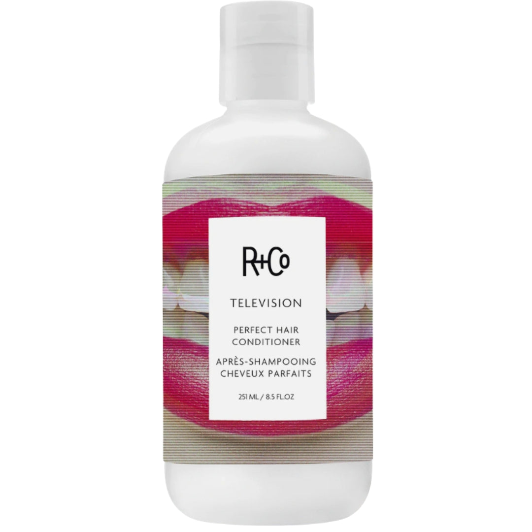Bottle of TELEVISION Perfect Hair Conditioner by R+Co with a white background and a label featuring a smiling mouth with red lips