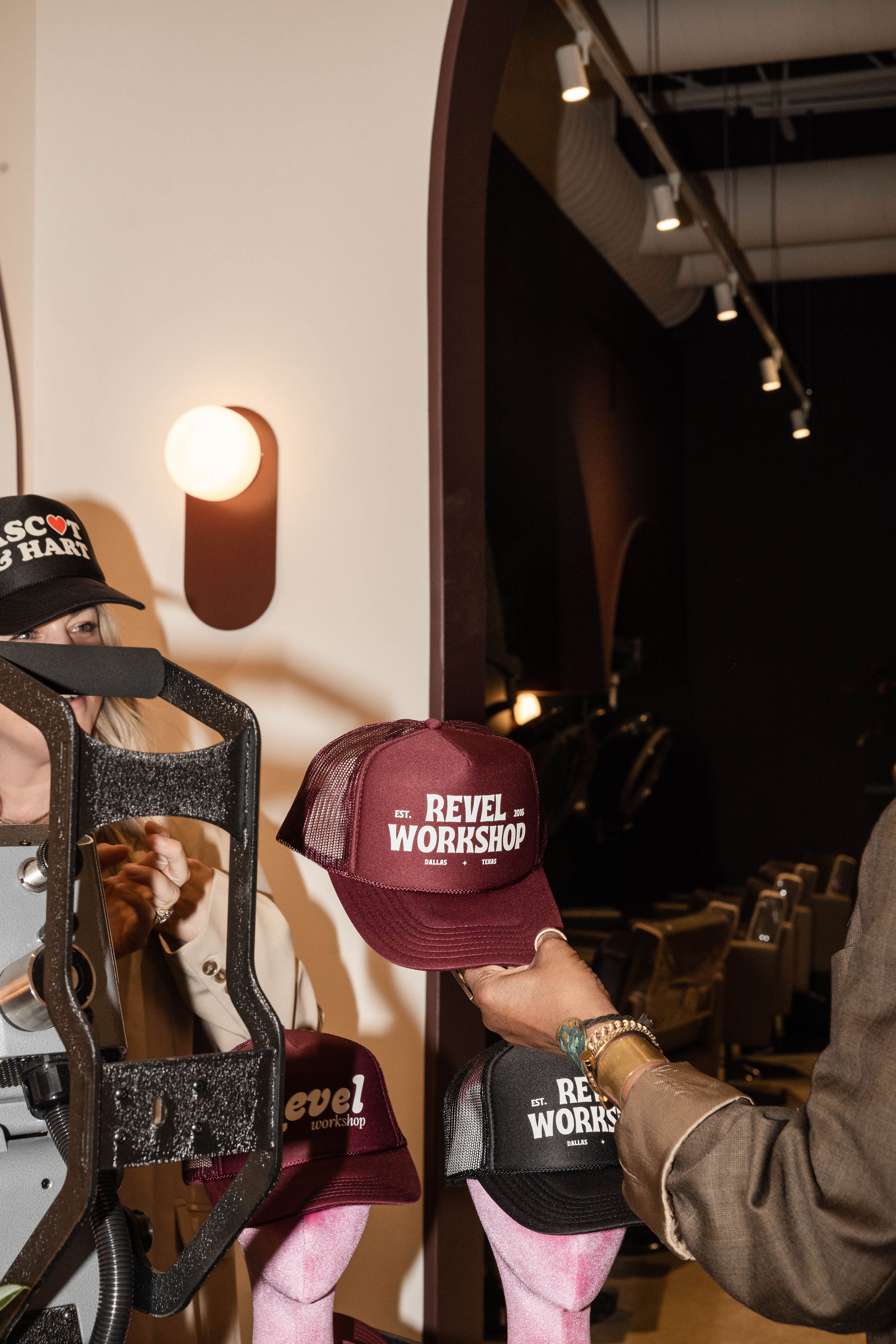 Inside the hair salon, the Ascot and Hart team creates custom trucker hats for Revel Workshop