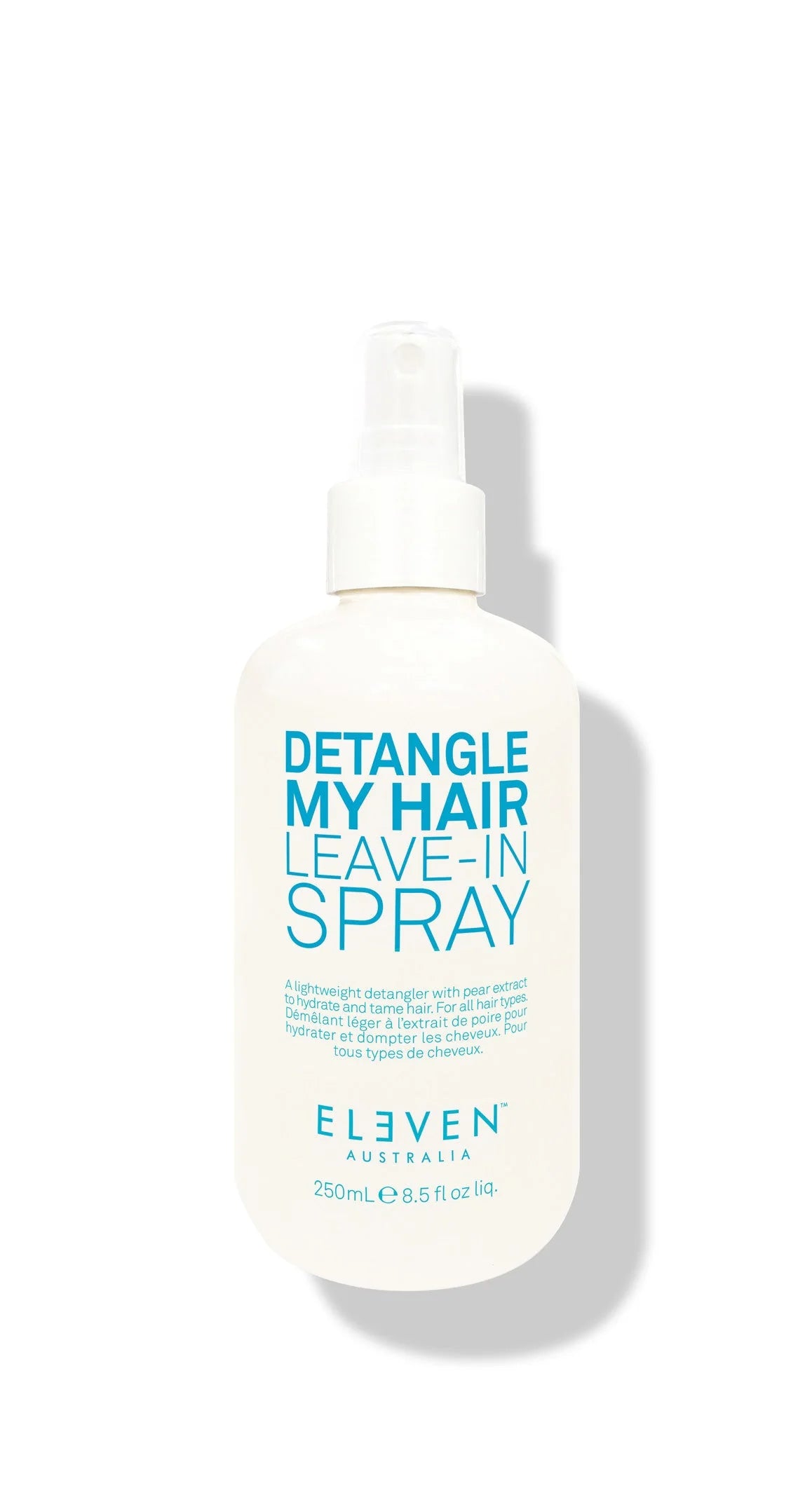 A white spray bottle labeled 'Detangle My Hair Leave-In Spray' by ELEVEN.