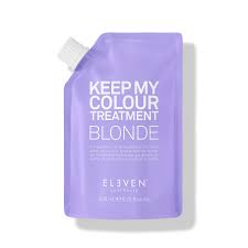 A purple pouch of hair color treatment product labeled 'KEEP MY COLOUR TREATMENT BLONDE' from the brand ELEVEN.