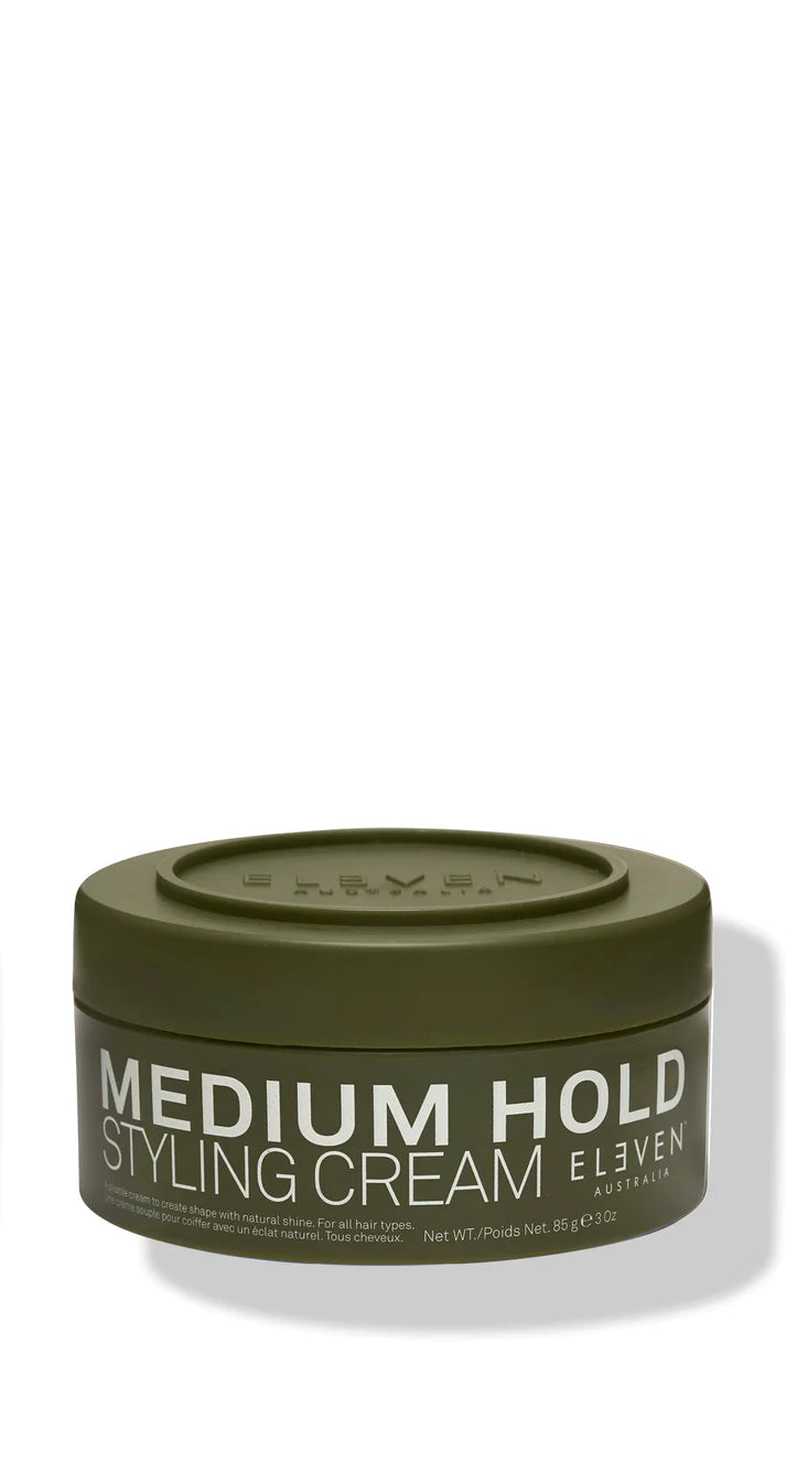 Green container of Medium Hold Styling Cream by ELEVEN.