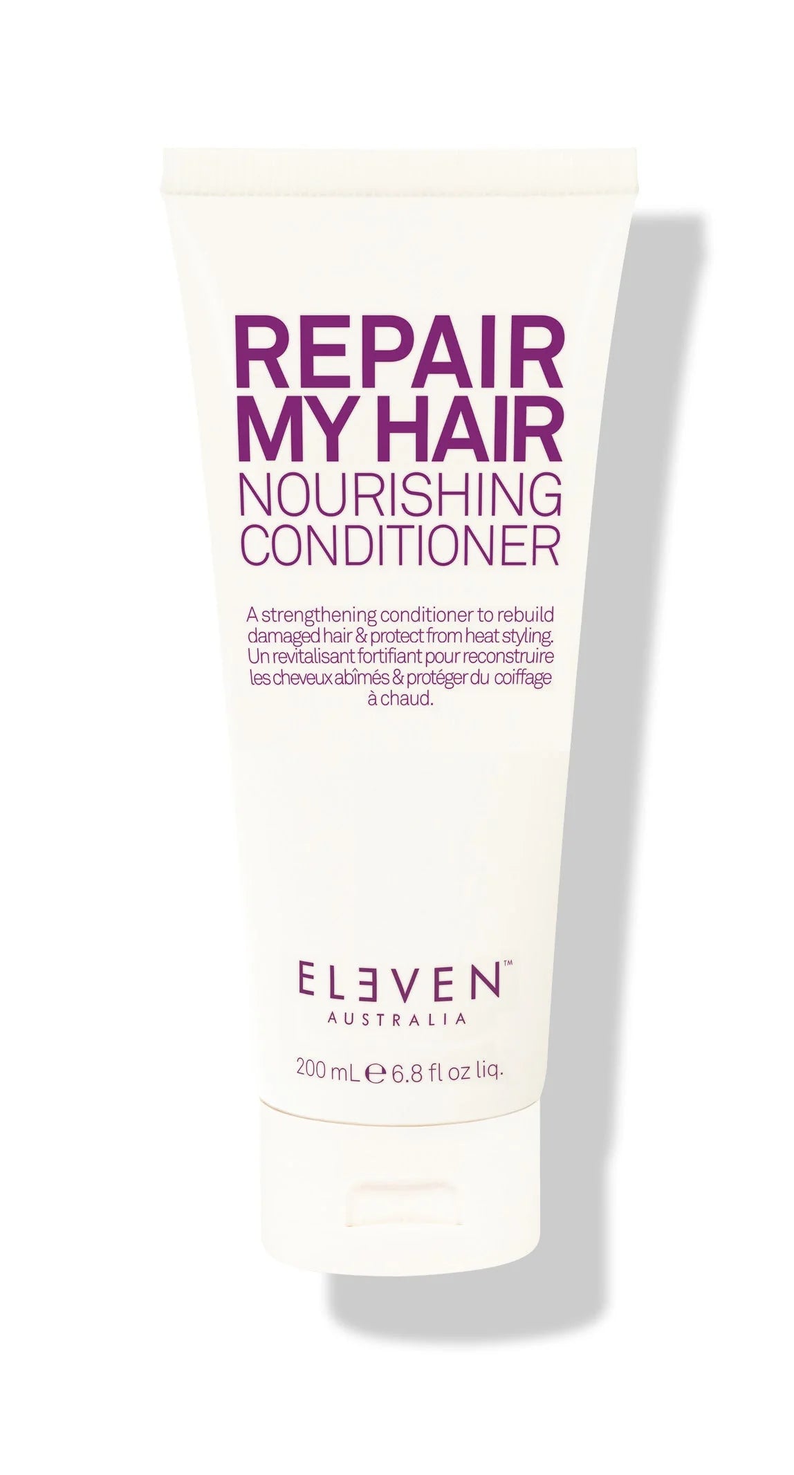 A tube of ELEVEN brand Repair My Hair Nourishing Conditioner with purple and white packaging.