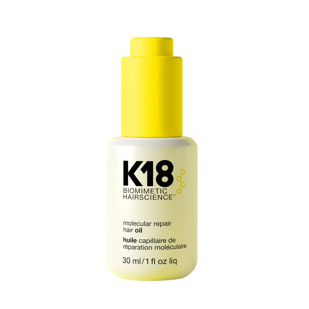 White and yellow bottle of K18 Biomimetic Hairscience - molecular repair hair oil