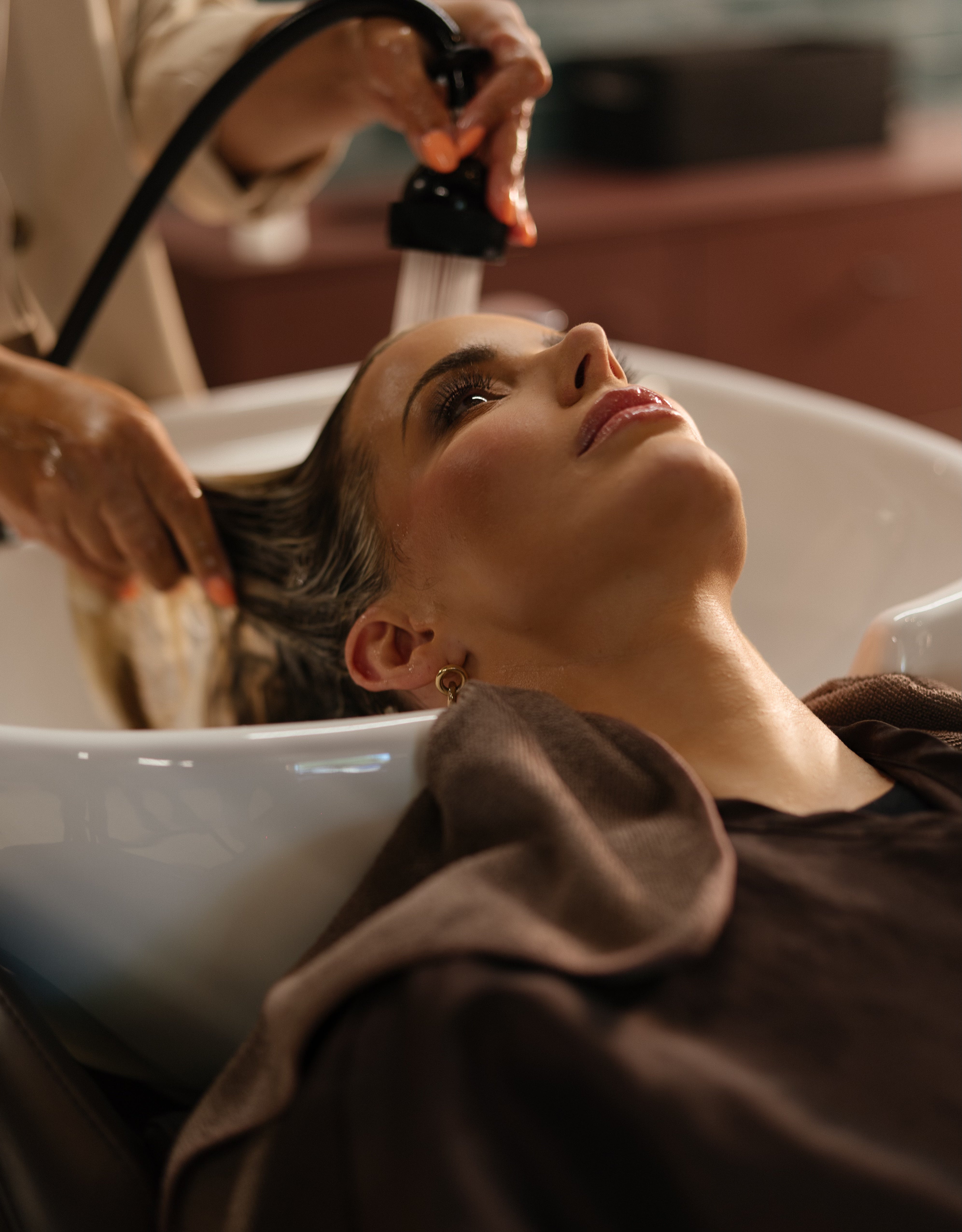 Woman getting a hair wash in a salon setting