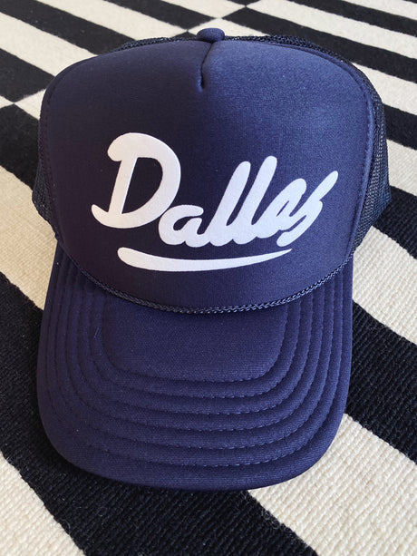 Blue trucker hat with the word 'Dallas' on the front in white letters