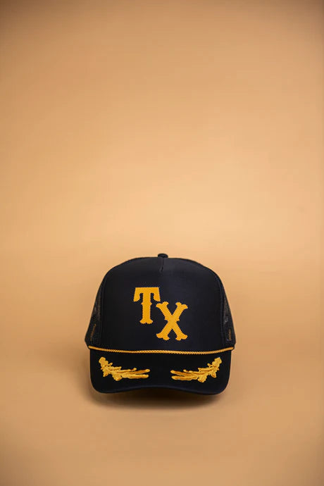 A black trucker hat with 'TX' in large, yellow letters on the front.