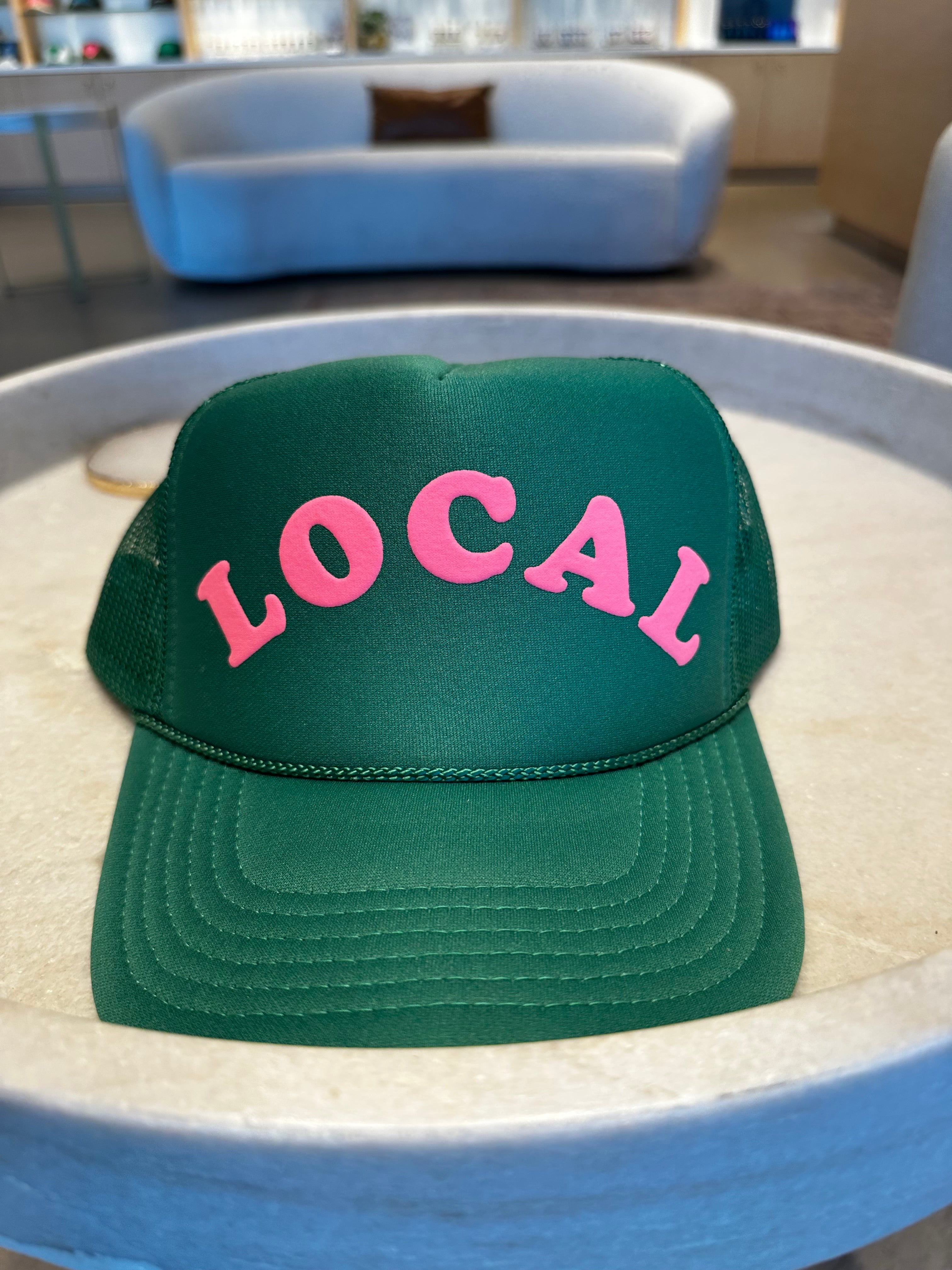 Green trucker hat with the word 'LOCAL' on the front in pink letters