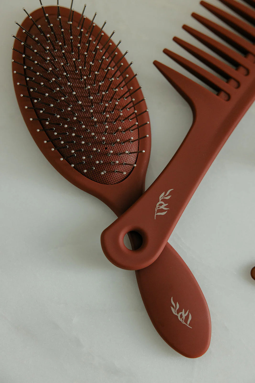 Brown Willow detangling hairbrush and comb set on a light background