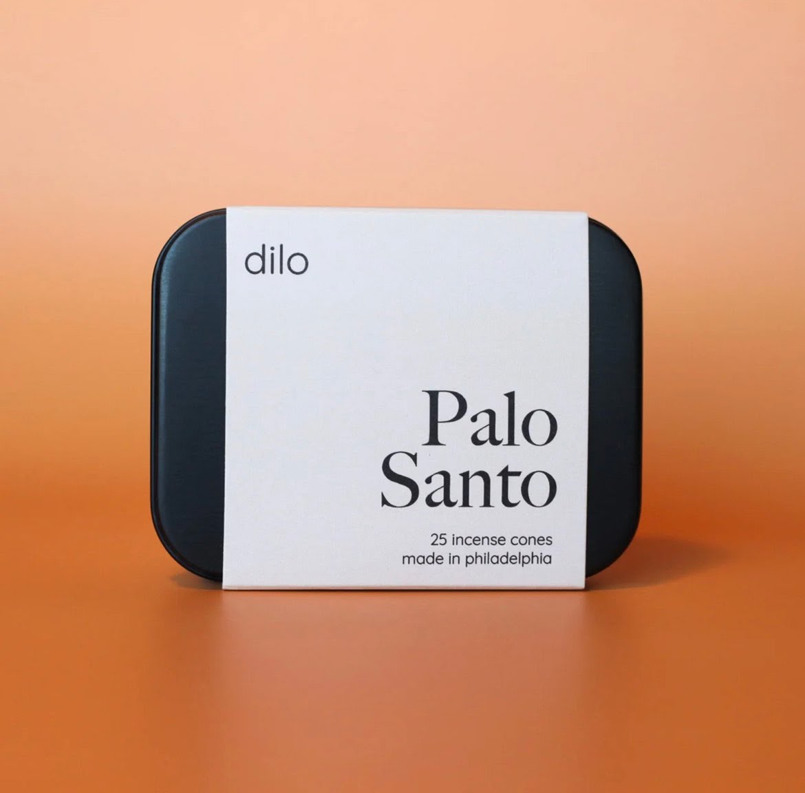 Black tin of Dilo brand Palo Santo incense cones in light color retail wrapper