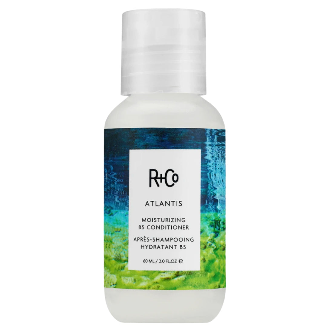 Travel size bottle of R+Co ATLANTIS Moisturizing B5 Conditioner hair product with blue and green label