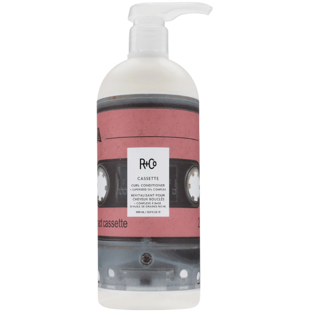 A bottle of Cassette Curl Conditioner by R+Co, with a cassette tape image on the label