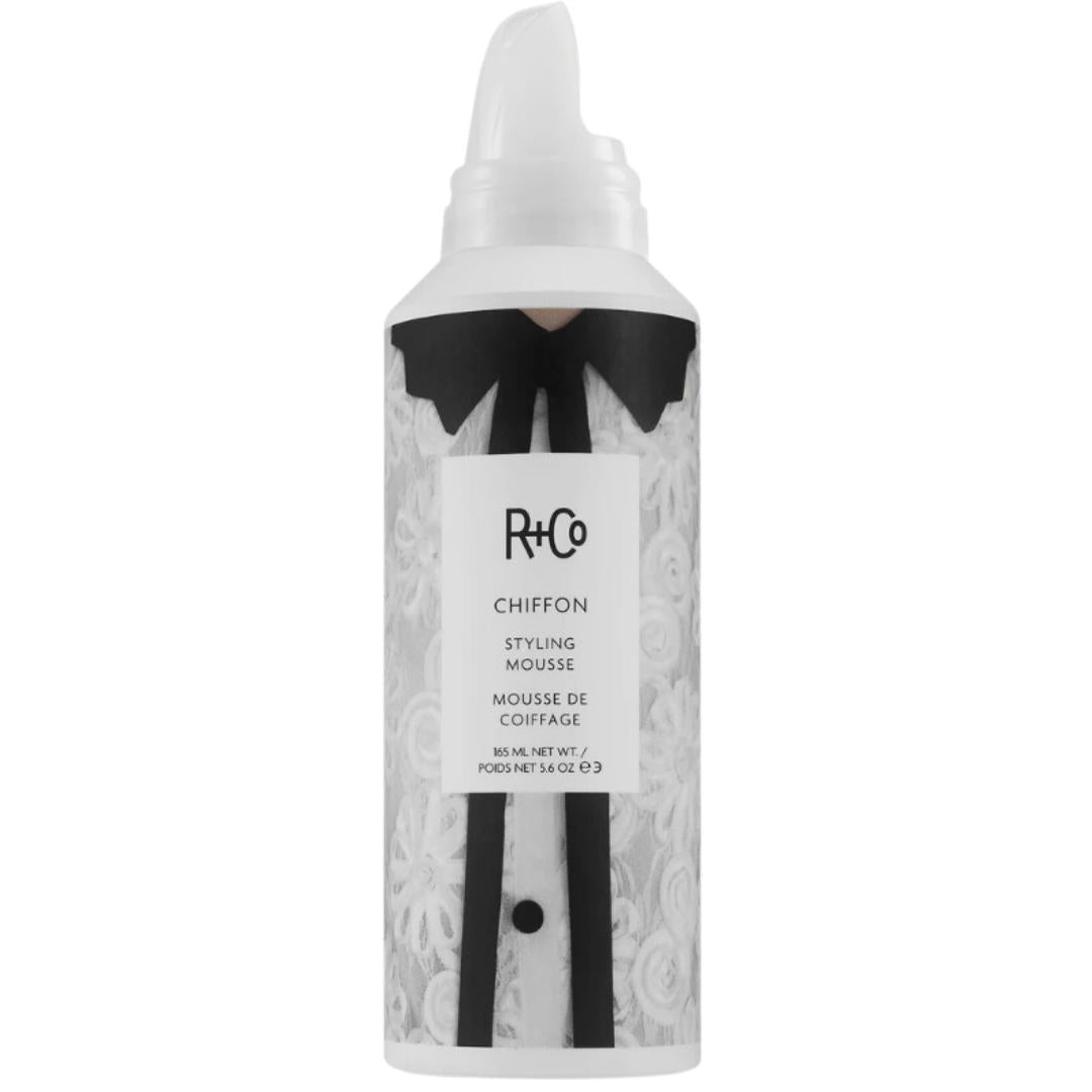 A can of Chiffon Styling Mousse with a white and black label, designed for providing volume and shine to hair.