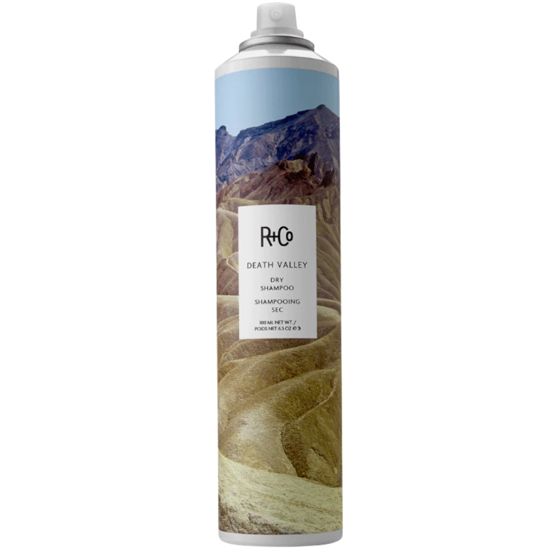 A can of Death Valley Dry Shampoo by R+Co with a mountainous landscape design.