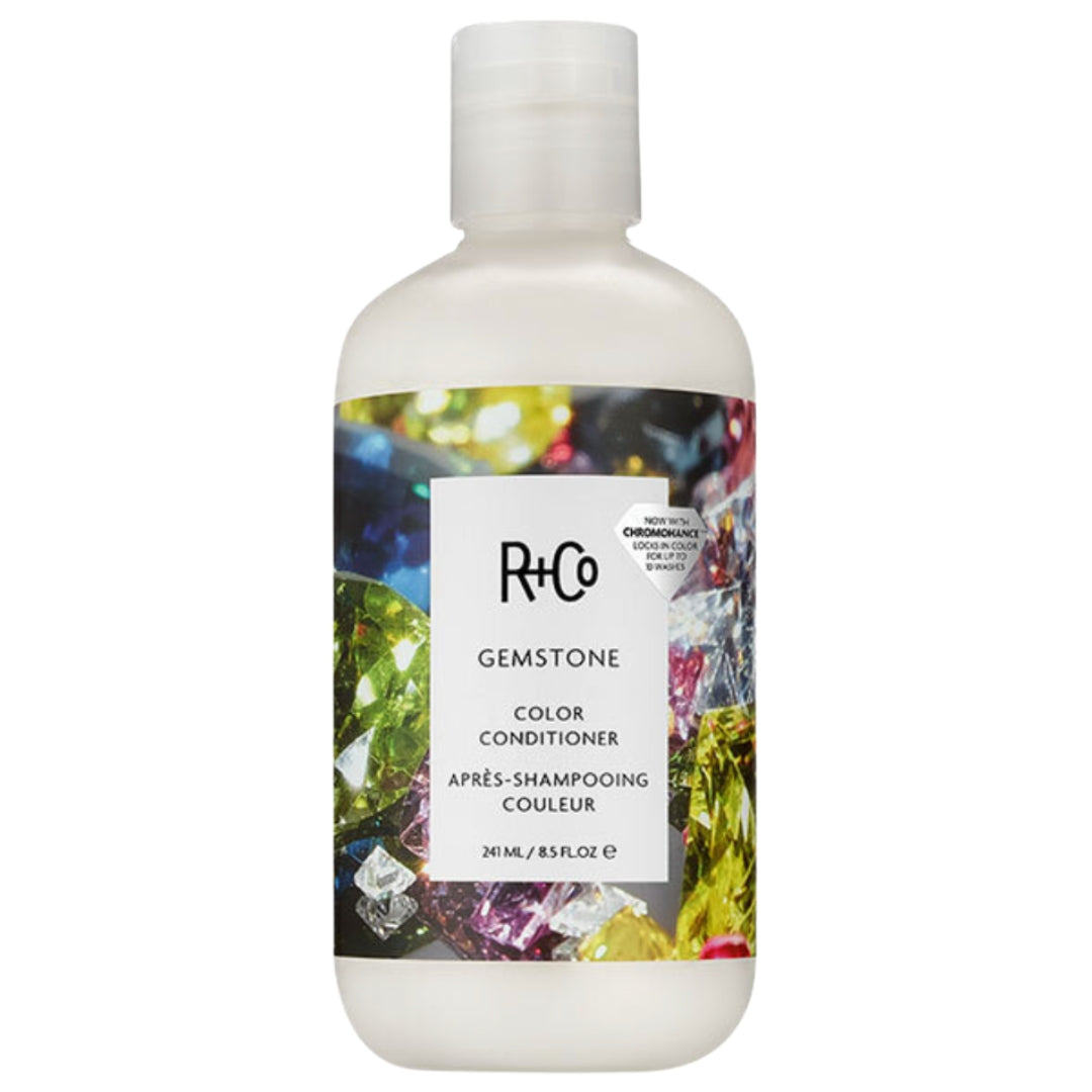 A bottle of R+Co Gemstone Color Conditioner with a colorful gemstone image on the label.