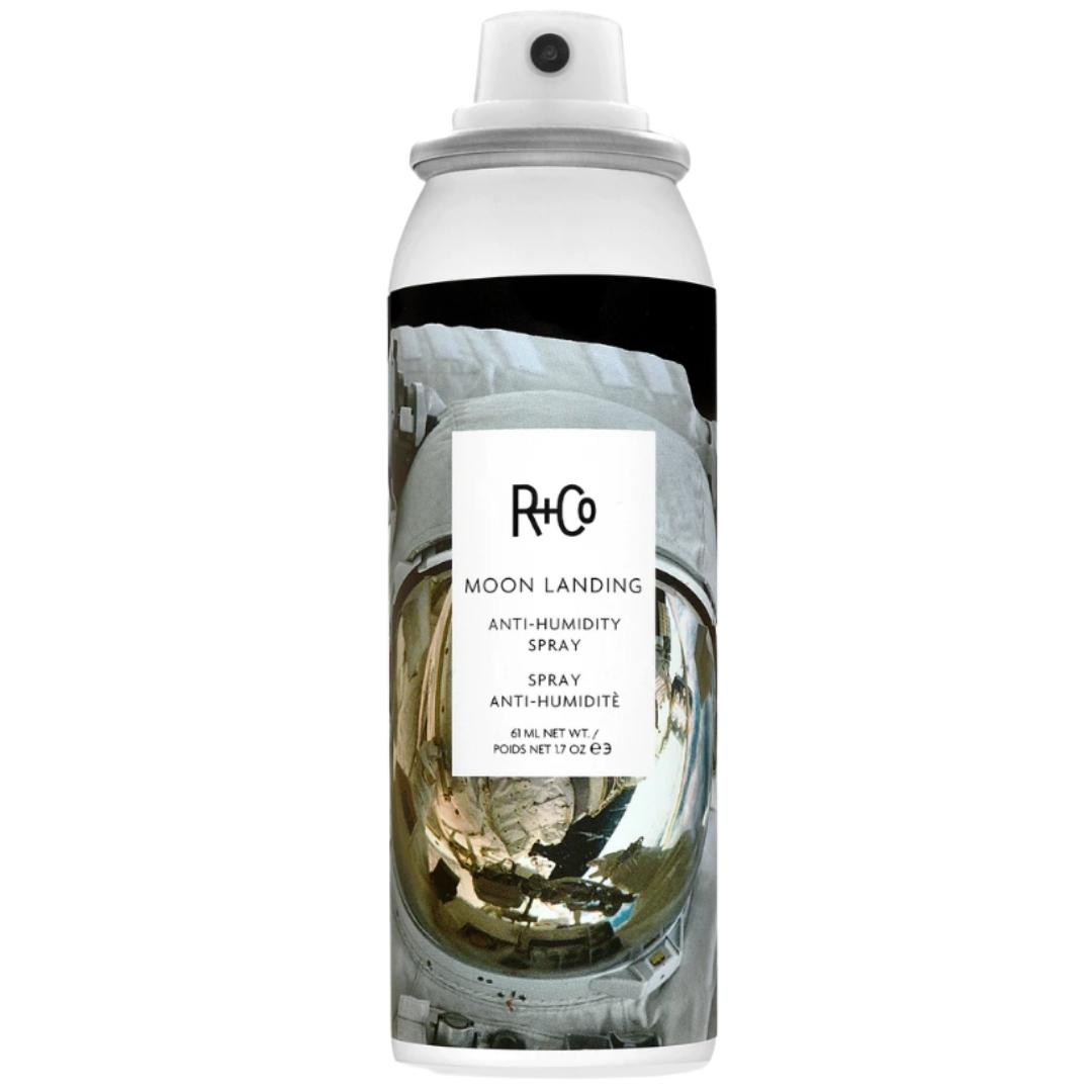 White can of R+Co Moon Landing Anti-Humidity Spray hair product with space suit image on label