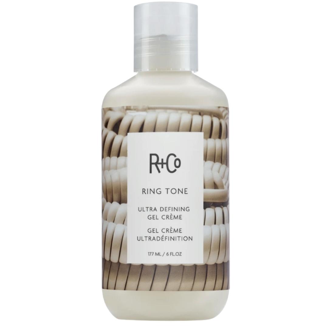 White bottle of R+Co Ring Tone Ultra Defining Gel Creme with image of coiled telephone cords on the label