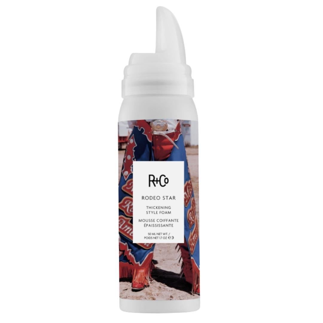 White container of RODEO STAR Thickening Styling Foam by R+Co with a colorful label featuring a person wearing a cowboy boots.