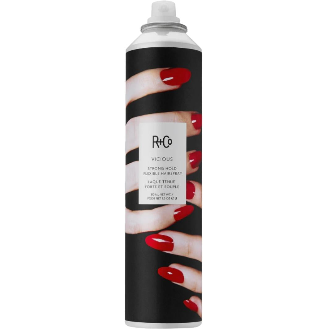 Black and white can of R+Co Vicious Strong Hold Flexible Hair Spray with image of hands with red fingernails on label