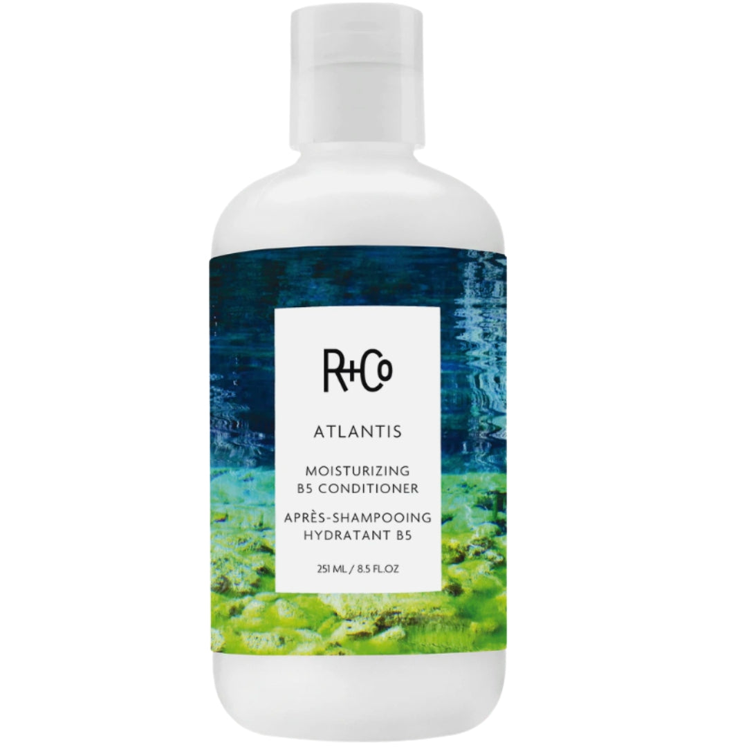 Bottle of R+Co ATLANTIS Moisturizing B5 Conditioner hair product with blue and green label